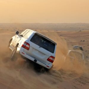 4x4 vehicles riding over sand Dunes on a desert safari in Dubai