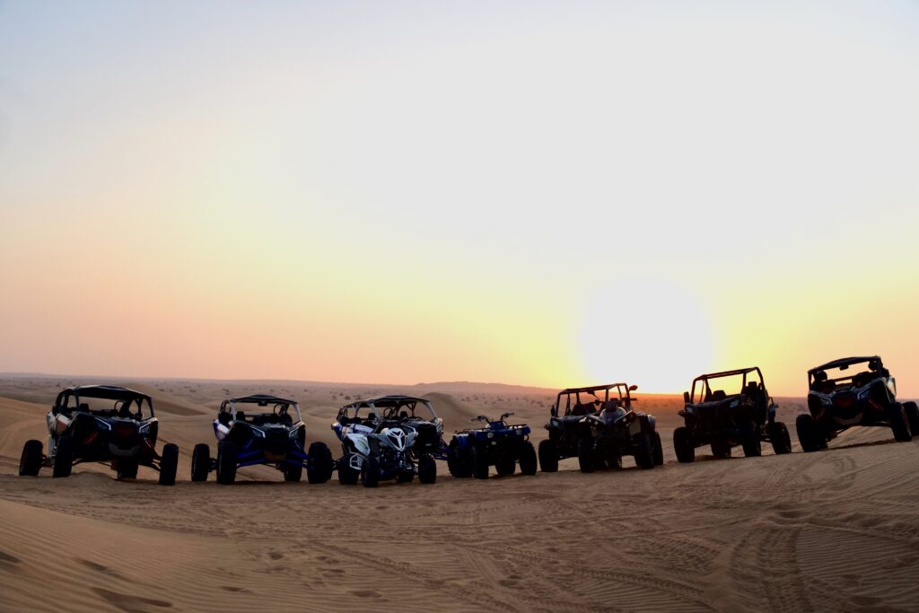 Monster Experience off road quad bike atv and four wheeler lined up in the dubai desert