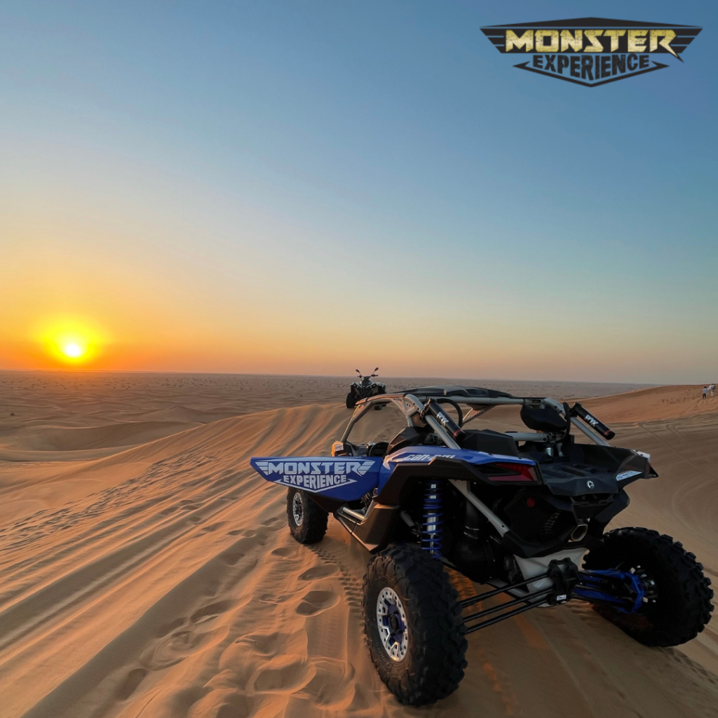 Dune buggy parked on a sand dune in Dubai during sunset