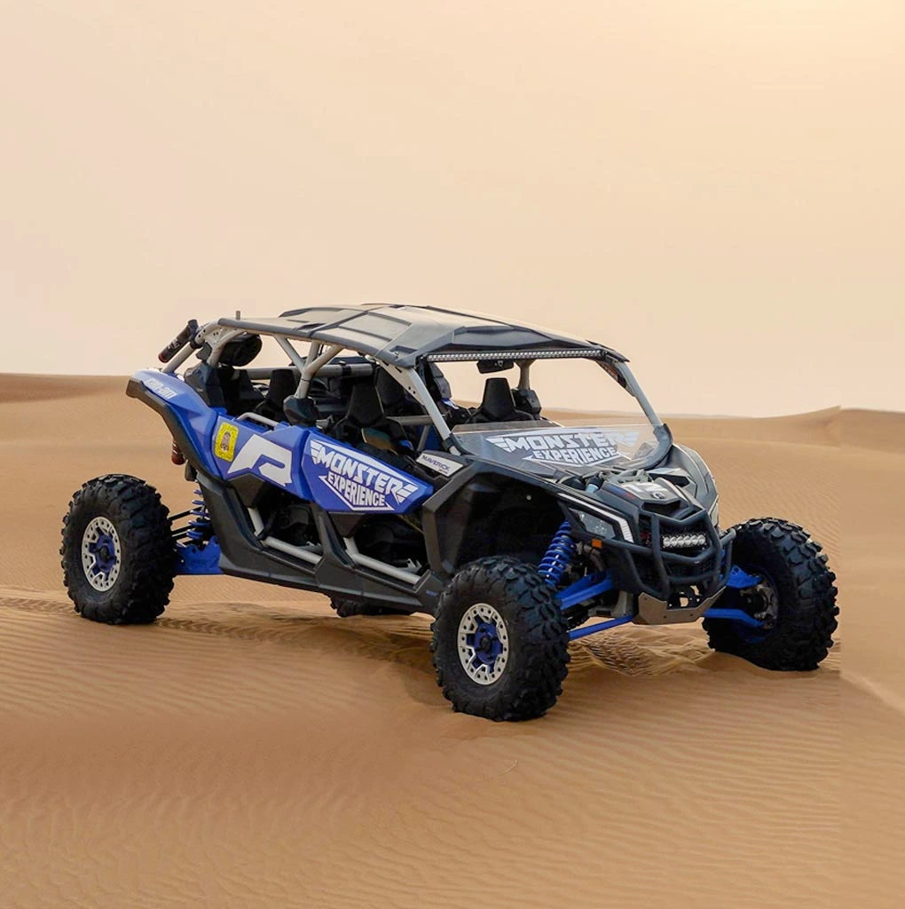 4 seater blue buggy in dubai desert. can am maverick x3 turbo blue buggy in desert