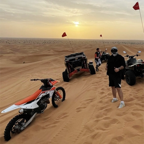 some guys with KTM 450CC, buggy and quad in the desert