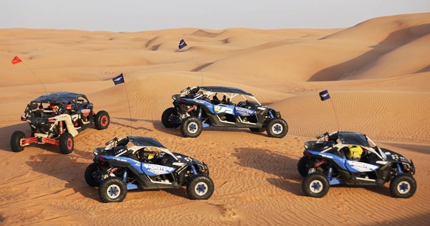 Several buggies in the dunes of the desert in Dubai