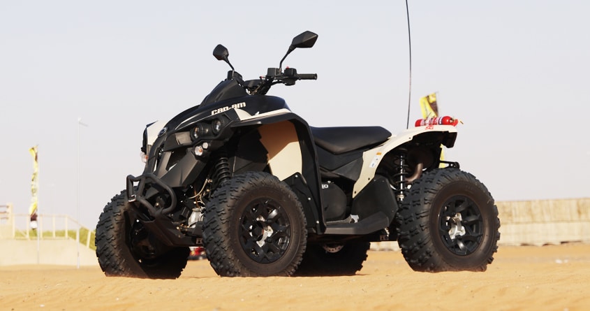 A black and white yamaha renegade quad in the desert 