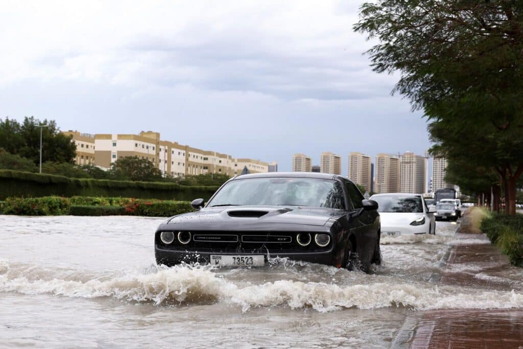 car in the middle of Dubai's flooded street after Dubai Flood April 2024