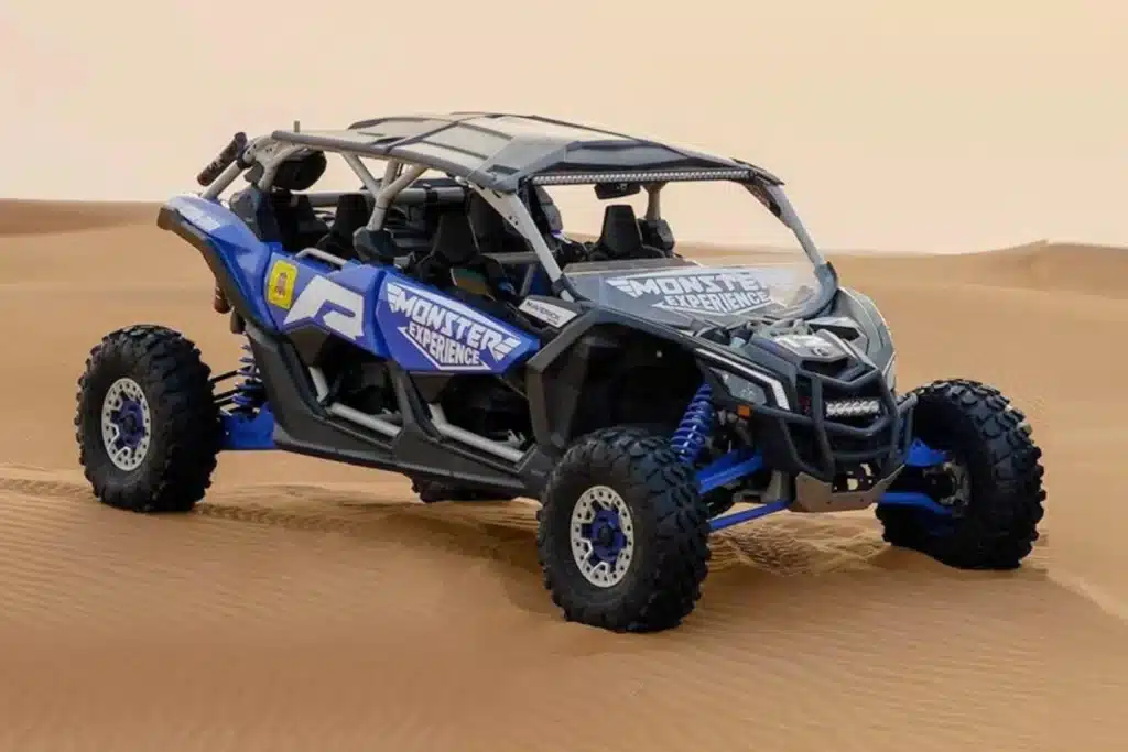 4 seater blue buggy in dubai desert. can am maverick x3 turbo blue buggy in desert