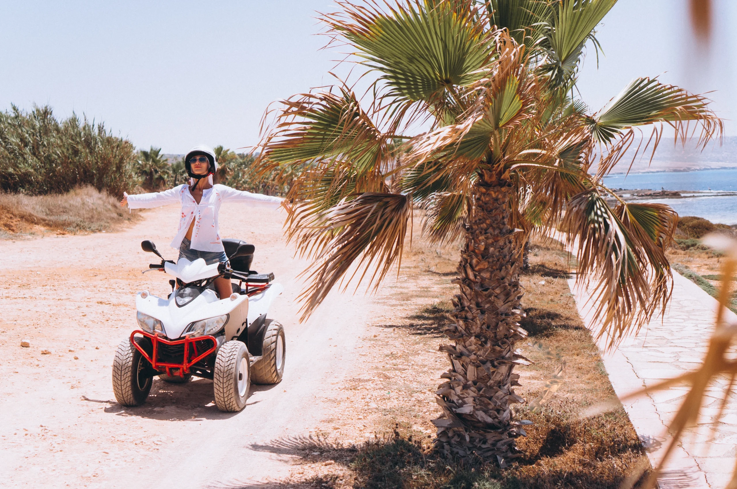 woman-travelling-quad-by-th-ocean-scaled