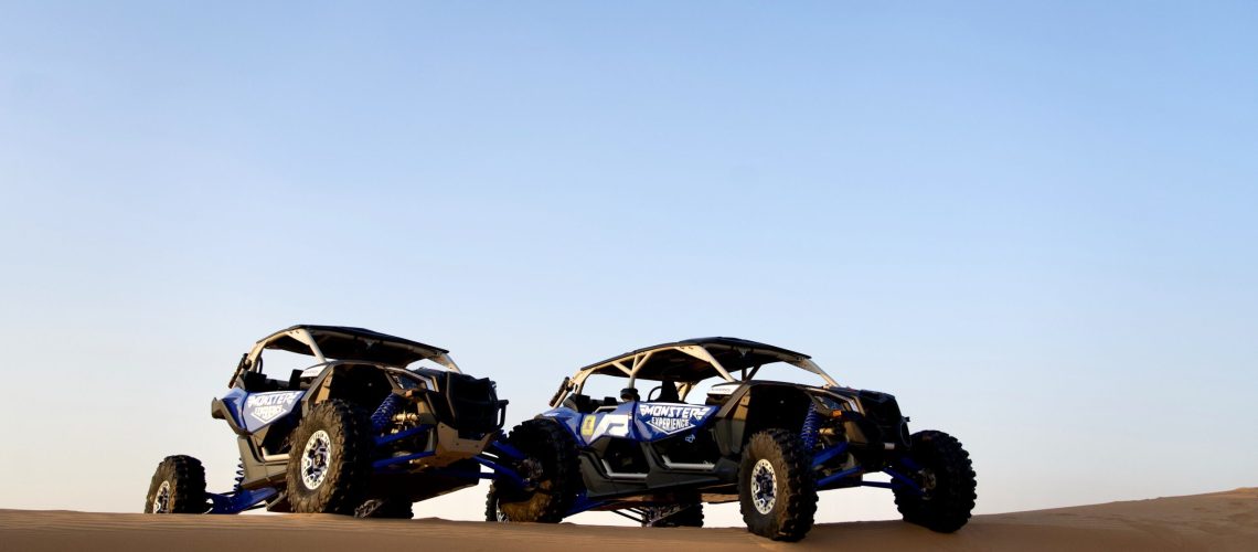 two blue dune buggies in the desert