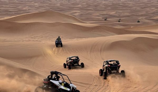 squad of dune buggies riding the dunes