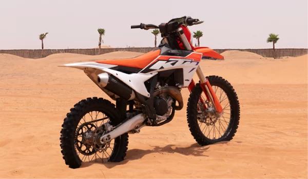 Orange color motorcycle photo from backside in the desert. KTM 450CC in desert.