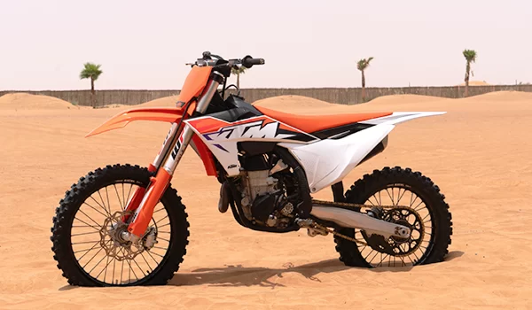 Orange color motorcycle stand still in the desert. KTM 450CC in desert.